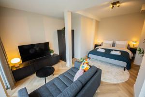 a living room with a bed and a couch at Studio serviced apartments with City view (KS71-R) in Hilversum