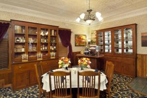 a dining room with a table with flowers on it at The Historic Elk Mountain Hotel in Elk Mountain