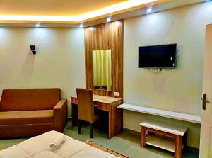 a hospital room with a bed and a tv on the wall at شقة داخل كمباوند in Hurghada