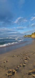 a pair of footprints in the sand on a beach at Oasis Blue Lozenets in Lozenets