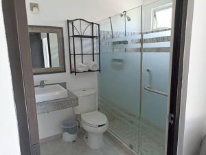 y baño con aseo, lavabo y ducha. en Casa Kante, en Puerto Morelos