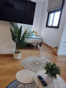 a living room with two tables and a couch at Apartamentos Pirra - Aeropuerto Ifema in Madrid