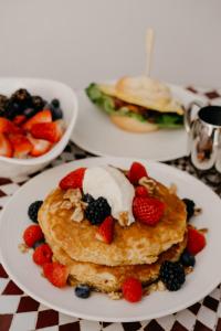 a plate of pancakes with fruit and ice cream at Esme Miami Beach in Miami Beach