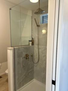 a shower with a glass door in a bathroom at Fox Ridge-Black Alder Lodging in Logan +30 photos