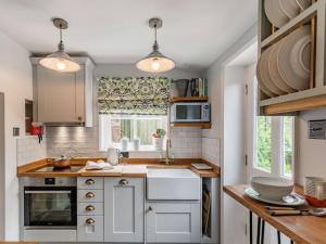 uma cozinha com armários brancos e uma janela em 1 Bed in Normanby 79105 em Normanby