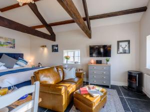- une chambre avec un lit et un canapé en cuir dans l'établissement 1 Bed in Exmoor 81477, à Challacombe