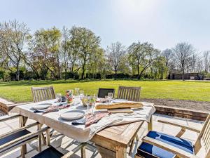 a wooden table with chairs and a laptop on it at 1 Bed in Uckfield 82279 