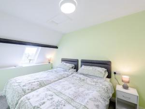a bedroom with a bed and a window at 2 Bed in Westward Ho 80350 in Northam