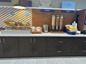 a kitchen with a counter with food on it at Holiday Inn Express & Suites Mountain View, an IHG Hotel in Mountain View