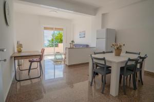 a kitchen and dining room with a table and chairs at Casa Erika in Bova Marina