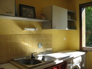 eine Küche mit einem Waschbecken und einem Fenster in der Unterkunft Gîte chez Emy et Seb in Privas