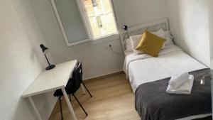 a small bedroom with a bed and a desk at PLAZA ANDALUCIA APARTMENT - Con Encanto in Córdoba