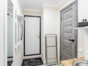 a bathroom with a door with a chalkboard on the floor at Отличная студия в центре in Almaty +8 photos