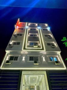 un edificio blanco con luces encima en MASA HOTEL APARTMENT en Mansoura