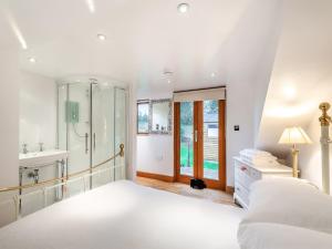 a white bedroom with a sink and a shower at Little Batley House in Westgate-on-Sea