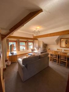 a living room with a couch and a table at Garnett - Comfy apartment, great location! in Clitheroe