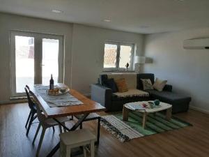 a living room with a table and a couch at zélu apartamento centro da Guarda in Guarda