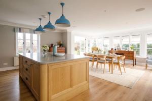 a kitchen and dining room with a table and chairs at Luxury Boltholes Fallow Grange in Chichester