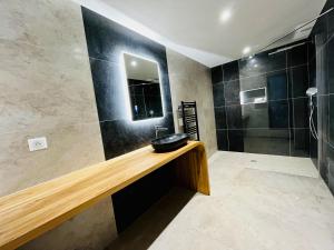 a bathroom with a sink and a shower at Hôtel Le Troubadour à Rocamadour in Rocamadour