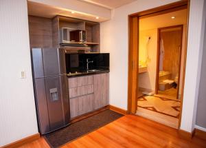 a kitchen with a stainless steel refrigerator and a microwave at Bogota Plaza Hotel in Bogotá