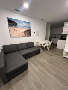 a living room with a couch and a table at Apartamentos BEACHYDAYS Metropolis B in Torremolinos