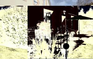 a black and white picture of a house with an umbrella at Holiday Home Saint Jean-Trolimon - 02 in Saint-Jean-Trolimon