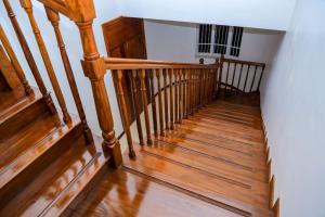 a wooden staircase with wooden floors and a stair case at a vacation home in Mbweni