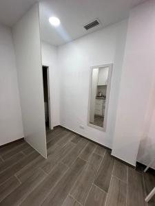 an empty room with a mirror and a wooden floor at Apartamentos Montalvo Metropolis C in Torremolinos