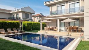 a swimming pool in the backyard of a house at Dalyan Villa Carmen-2 in Dalyan