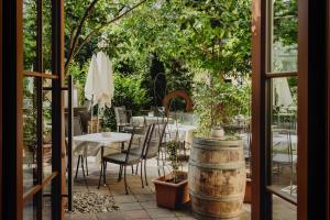 a patio with a table and chairs and trees at Der Stasta in Vienna