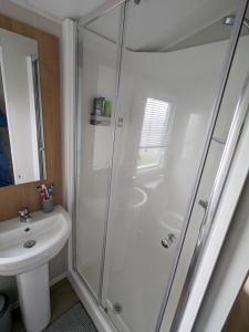 a bathroom with a shower and a sink at R&L'S RETREATS in Cayton