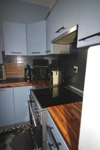 a kitchen with white cabinets and a stove top oven at Le grand bassin 10 min Disney 25 min Paris 11guests in Lognes