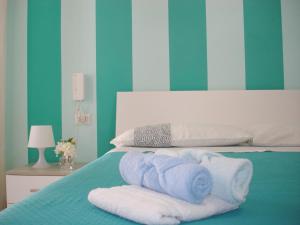 a bedroom with a bed with towels on it at B&B Margherita in Marina di Camerota