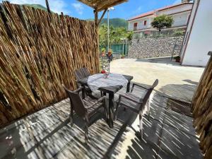 un tavolo e delle sedie seduti su un patio di La Casa di nonna Elena ad Agerola Altre 4 foto