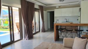 a kitchen and living room with a counter and a table at Dalyan Villa Carmen-2 in Dalyan