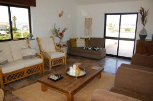 a living room with couches and a coffee table at UFitness Hotel in Vila Real de Santo António