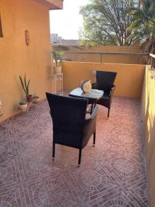 un patio con 2 sillas y una mesa en un patio en Azhares, en Copiapó