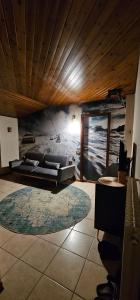 a living room with a couch and a painting on the wall at La Baita Residence 3.0 in Folgarida