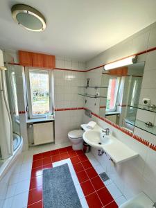 a bathroom with a white sink and a toilet at Central Villa with Garden in Ljubljana