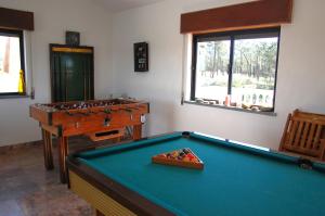 a billiard room with a pool table and a desk at UFitness Hotel in Vila Real de Santo António