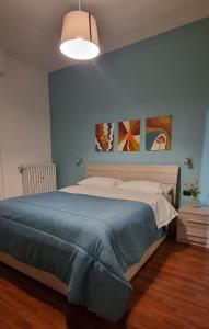 a bedroom with a large bed with a blue blanket at Metro Suite Milano in Milan