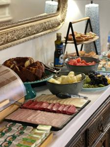 a buffet with meats and other food on a counter at 145 Townhouse in Ílhavo