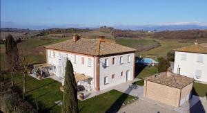 an aerial view of a large white house with trees at Agriturismo Antica Corte - Ortensie in Montepulciano