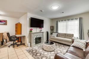 a living room with a couch and a fireplace at Cozy Newark Getaway about 15 Mi to Manhattan! in Newark