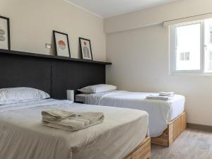 a bedroom with two beds and a window at Cozy 2BR Loft in the Heart of Miraflores in Lima +35 photos