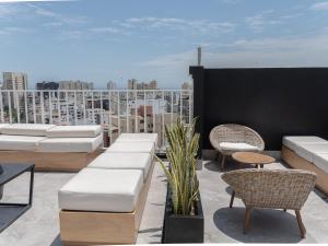 a rooftop patio with furniture and a view of a city at Cozy 2BR Loft in the Heart of Miraflores in Lima