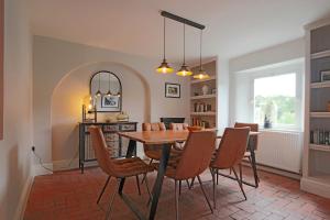 a dining room with a table and chairs at Beautiful Character Cottage in Milford