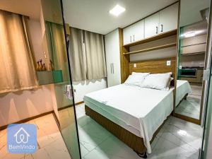A bed or beds in a room at Studio charmoso a 150m da praia de Piatã