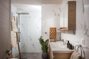 a bathroom with a sink and a shower at BELLA CASA LUXURY SUITES in Svoúrou Metókhion