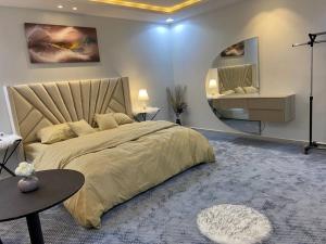 a bedroom with a large bed and a circular mirror at غرفه مستقله بدورة مياه حي طويق in Riyadh